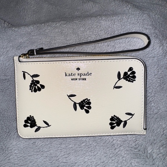 kate spade Handbags - Kate Spade Ivory Wristlet with Black Floral Pattern
